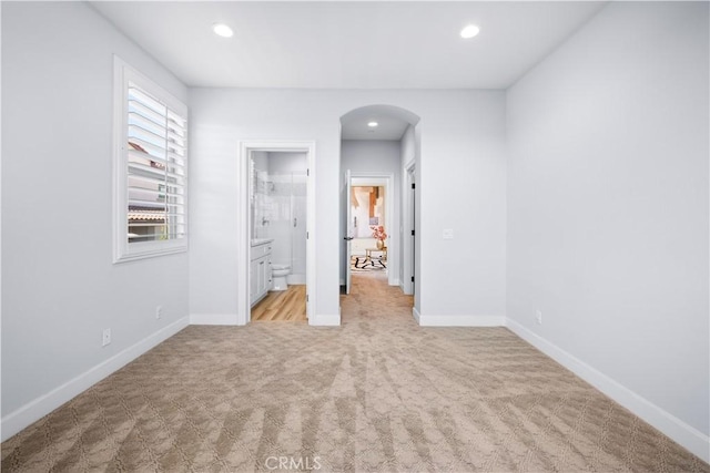 16389 Viewcrest Rd, Chino Hills, CA 91709 - unfurnished bedroom with arched walkways, light colored carpet, recessed lighting, and ensuite bathroom