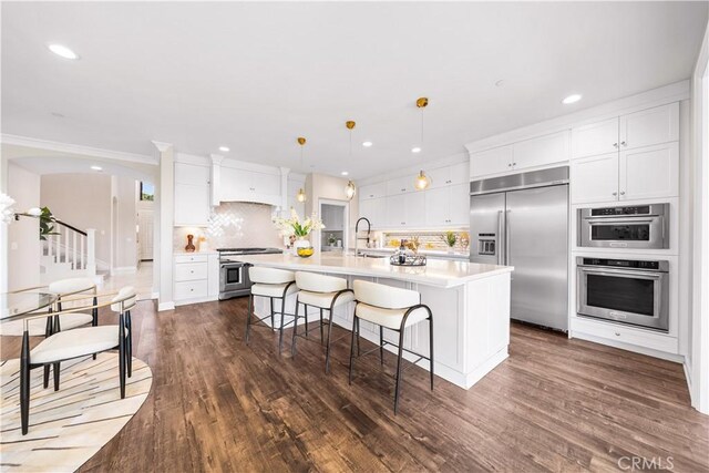 16389 Viewcrest Rd, Chino Hills, CA 91709 - kitchen featuring appliances with stainless steel finishes, tasteful backsplash, light countertops, dark wood finished floors, and recessed lighting