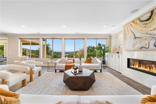 16389 Viewcrest Rd, Chino Hills, CA 91709 - living room with wood finished floors, a glass covered fireplace, recessed lighting, and ornamental molding