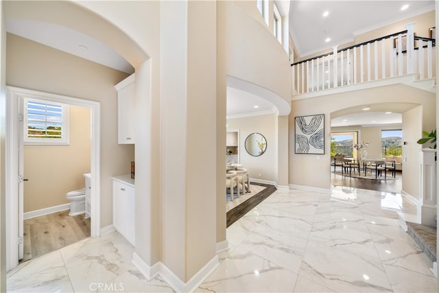 16389 Viewcrest Rd, Chino Hills, CA 91709 - foyer featuring light marble finish flooring, crown molding, plenty of natural light, arched walkways, and recessed lighting