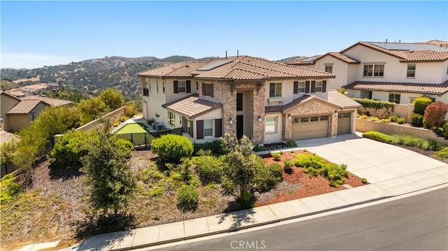 16389 Viewcrest Rd, Chino Hills, CA 91709 - view of front of house with a garage, driveway, stone siding, stucco siding, and a tile roof
