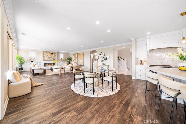16389 Viewcrest Rd, Chino Hills, CA 91709 - dining area with recessed lighting, a large fireplace, dark wood-type flooring, arched walkways, and ornamental molding