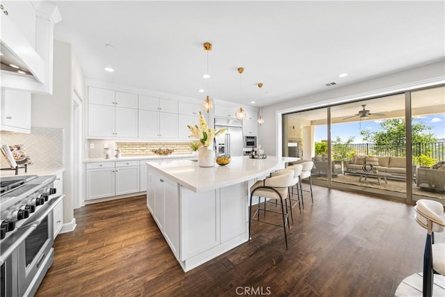 16389 Viewcrest Rd, Chino Hills, CA 91709 - kitchen with premium appliances, decorative backsplash, dark wood-style floors, recessed lighting, and light countertops