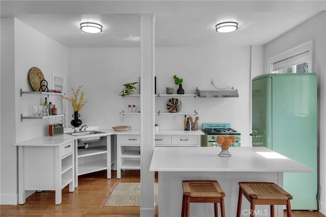 360 W Ocean Blvd Unit 402, Long Beach, CA 90802 - kitchen with open shelves, gas range, extractor fan, freestanding refrigerator, and light wood-style floors