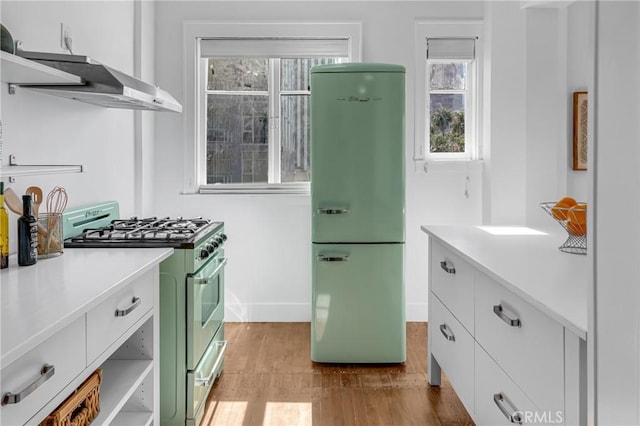 360 W Ocean Blvd Unit 402, Long Beach, CA 90802 - kitchen featuring freestanding refrigerator, high end stainless steel range, light wood-type flooring, and light countertops