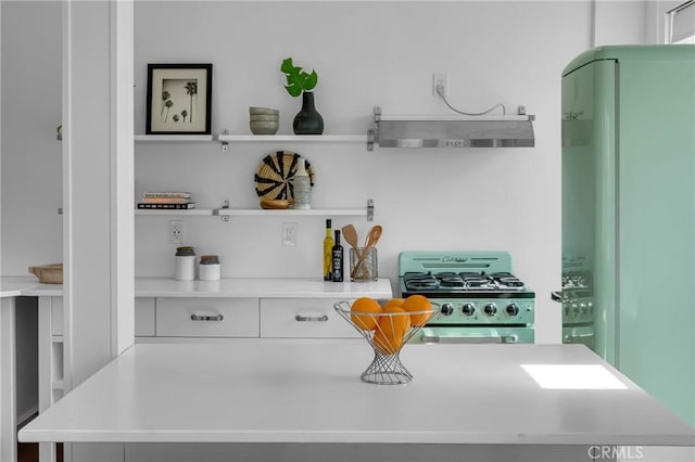 360 W Ocean Blvd Unit 402, Long Beach, CA 90802 - kitchen with range, exhaust hood, open shelves, and light countertops