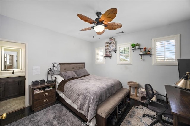 5231 Flora Ct, Rancho Cucamonga, CA 91739 - bedroom featuring dark wood-style flooring, a desk, connected bathroom, and a ceiling fan