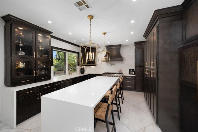 5231 Flora Ct, Rancho Cucamonga, CA 91739 - kitchen with a kitchen bar, a kitchen island, custom exhaust hood, glass insert cabinets, and light countertops