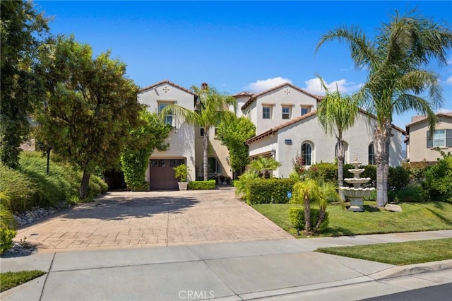 5231 Flora Ct, Rancho Cucamonga, CA 91739 - mediterranean / spanish home with decorative driveway, an attached garage, stucco siding, and a tiled roof