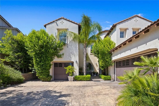 5231 Flora Ct, Rancho Cucamonga, CA 91739 - mediterranean / spanish-style home featuring a tiled roof, stucco siding, and decorative driveway