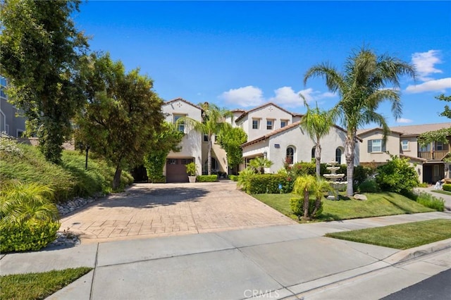 5231 Flora Ct, Rancho Cucamonga, CA 91739 - mediterranean / spanish-style home with decorative driveway, a residential view, stucco siding, a front yard, and a garage
