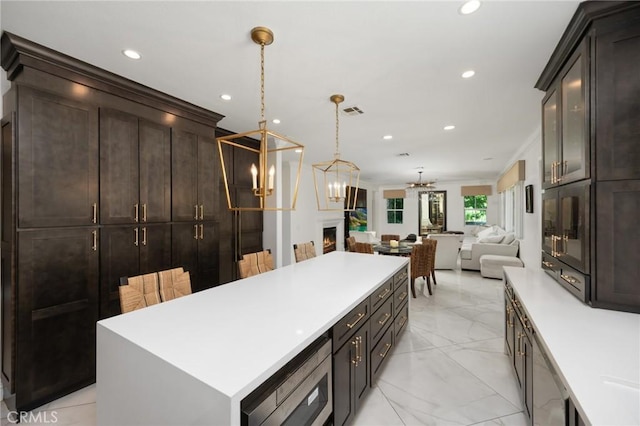 5231 Flora Ct, Rancho Cucamonga, CA 91739 - kitchen featuring a chandelier, a center island, light countertops, open floor plan, and recessed lighting