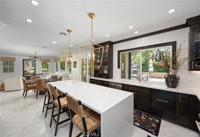5231 Flora Ct, Rancho Cucamonga, CA 91739 - kitchen featuring a chandelier, ornamental molding, light countertops, recessed lighting, and open floor plan