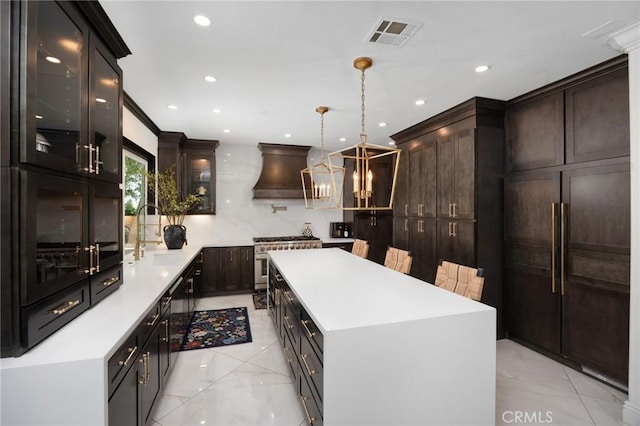 5231 Flora Ct, Rancho Cucamonga, CA 91739 - kitchen with high quality appliances, custom exhaust hood, glass insert cabinets, light countertops, and a kitchen island