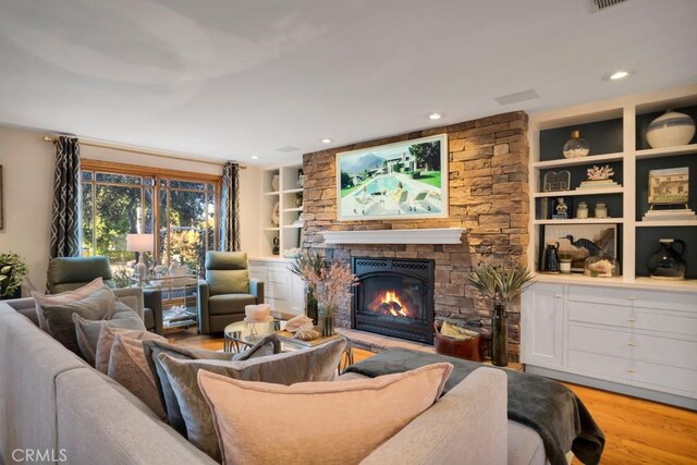 24630 Kittridge St, West Hills, CA 91307 - living room featuring a stone fireplace, wood finished floors, recessed lighting, and built in features