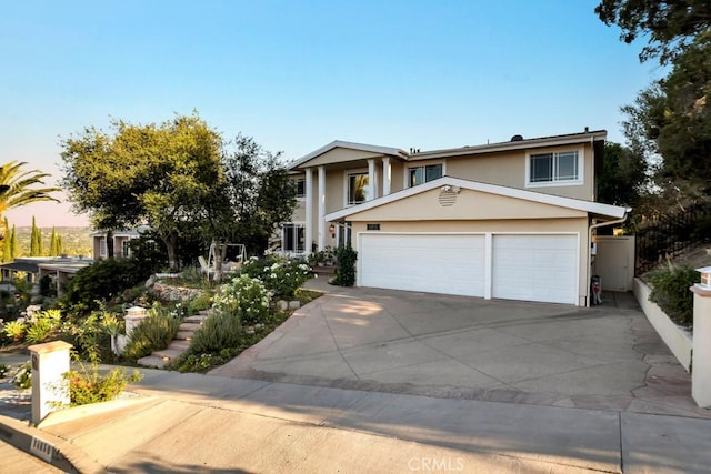 24630 Kittridge St, West Hills, CA 91307 - greek revival house featuring stucco siding, driveway, and a garage