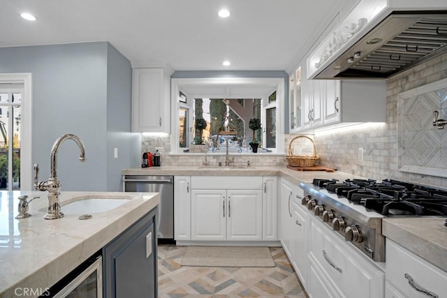 24630 Kittridge St, West Hills, CA 91307 - kitchen featuring exhaust hood, appliances with stainless steel finishes, backsplash, white cabinets, and recessed lighting