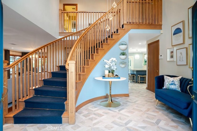 24630 Kittridge St, West Hills, CA 91307 - staircase featuring a towering ceiling and baseboards