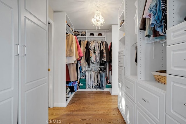 24630 Kittridge St, West Hills, CA 91307 - walk in closet with a chandelier and light wood-type flooring