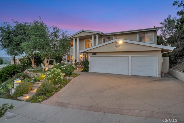 24630 Kittridge St, West Hills, CA 91307 - view of front facade featuring stucco siding, concrete driveway, and an attached garage