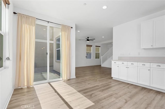 403 Aura Dr, Costa Mesa, CA 92626 - kitchen featuring light wood-type flooring, recessed lighting, white cabinets, ceiling fan, and light countertops