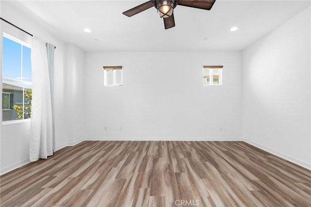 403 Aura Dr, Costa Mesa, CA 92626 - empty room with plenty of natural light, wood finished floors, a ceiling fan, and recessed lighting