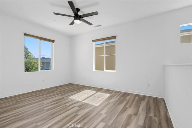 403 Aura Dr, Costa Mesa, CA 92626 - unfurnished room featuring healthy amount of natural light, wood finished floors, and a ceiling fan