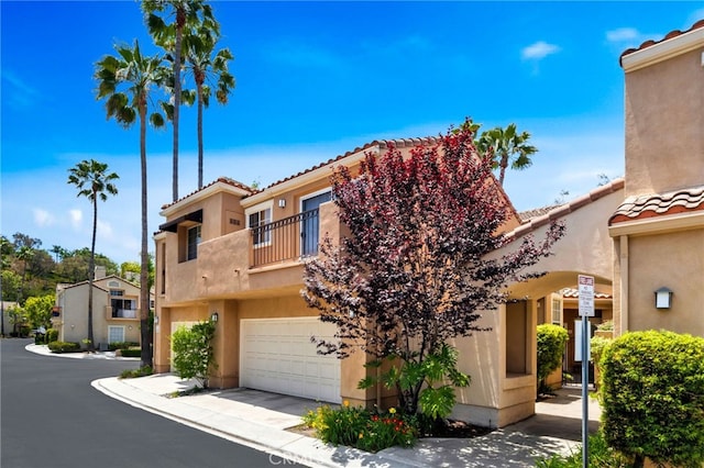 5 Chandon, Laguna Niguel, CA 92677 - view of front of home with a balcony, a garage, stucco siding, and a tile roof