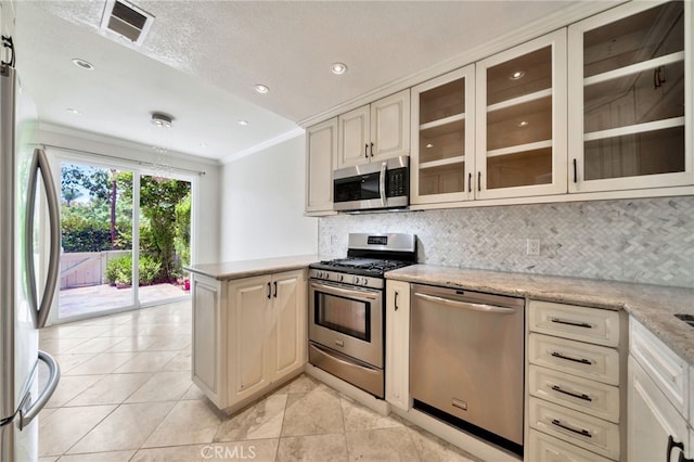 5 Chandon, Laguna Niguel, CA 92677 - kitchen featuring stainless steel appliances, crown molding, a peninsula, cream cabinets, and tasteful backsplash