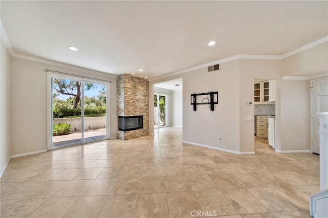 5 Chandon, Laguna Niguel, CA 92677 - unfurnished living room with crown molding, a stone fireplace, light tile patterned flooring, and recessed lighting