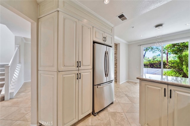 5 Chandon, Laguna Niguel, CA 92677 - kitchen featuring freestanding refrigerator, cream cabinets, light tile patterned floors, crown molding, and recessed lighting