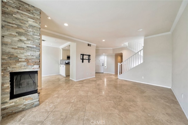 5 Chandon, Laguna Niguel, CA 92677 - unfurnished living room featuring ornamental molding, a stone fireplace, stairway, light tile patterned flooring, and recessed lighting