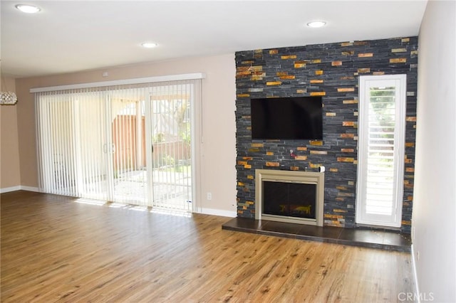 6584 E Paseo Diego, Anaheim, CA 92807 - unfurnished living room featuring wood finished floors, healthy amount of natural light, a fireplace, recessed lighting, and a chandelier
