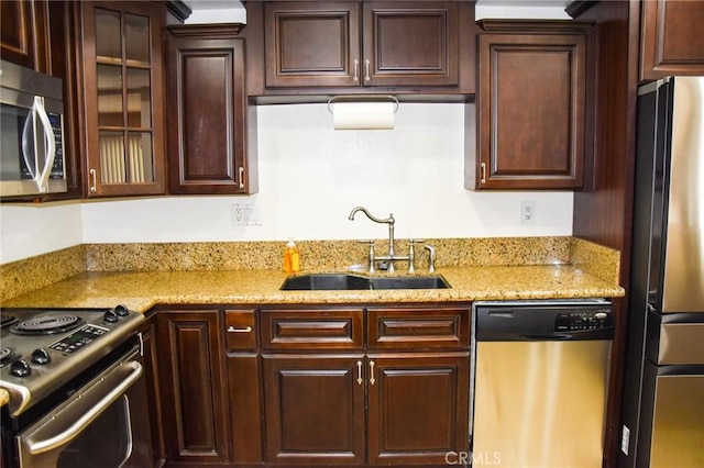 6584 E Paseo Diego, Anaheim, CA 92807 - kitchen with stainless steel appliances, dark brown cabinets, glass insert cabinets, and light stone counters