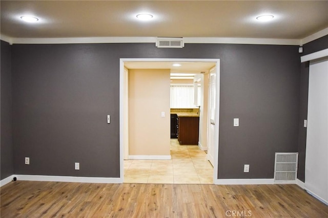 6584 E Paseo Diego, Anaheim, CA 92807 - spare room featuring light wood-style flooring, a barn door, and recessed lighting