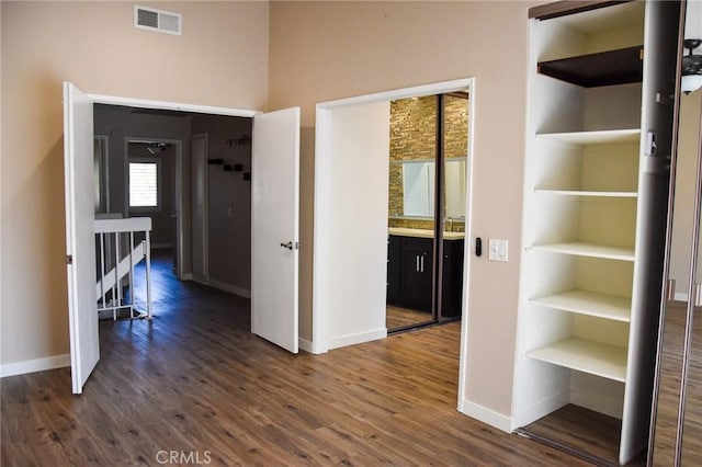 6584 E Paseo Diego, Anaheim, CA 92807 - hallway featuring dark wood finished floors and built in shelves