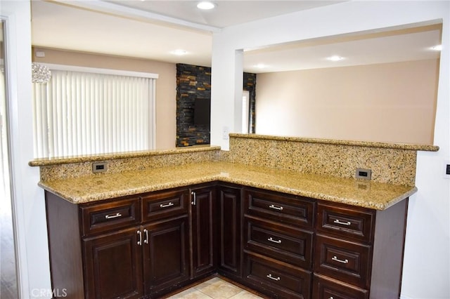6584 E Paseo Diego, Anaheim, CA 92807 - kitchen featuring light stone countertops, backsplash, dark brown cabinets, recessed lighting, and light tile patterned floors