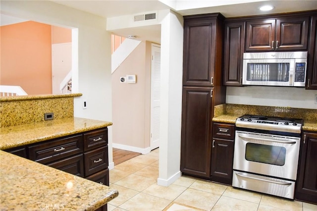 6584 E Paseo Diego, Anaheim, CA 92807 - kitchen with stainless steel appliances, light tile patterned floors, dark brown cabinetry, and light stone countertops