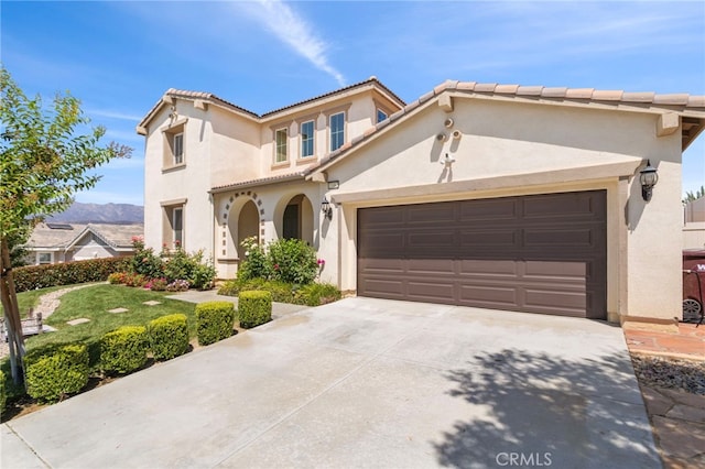 11462 Jacobsen Rd, Beaumont, CA 92223 - mediterranean / spanish house featuring stucco siding, driveway, a garage, and a tile roof