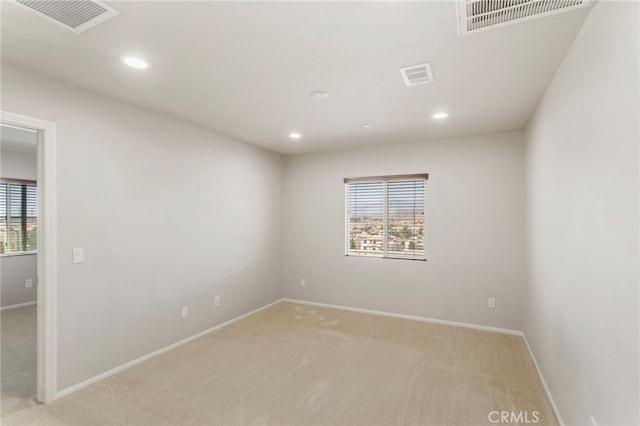 11462 Jacobsen Rd, Beaumont, CA 92223 - empty room with light carpet, healthy amount of natural light, and recessed lighting