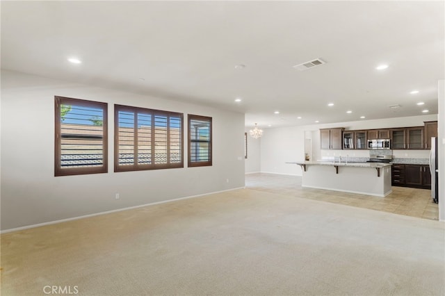 11462 Jacobsen Rd, Beaumont, CA 92223 - unfurnished living room featuring recessed lighting, a chandelier, and light carpet