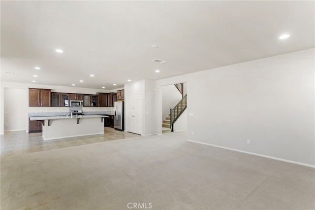 11462 Jacobsen Rd, Beaumont, CA 92223 - unfurnished living room featuring recessed lighting, stairs, and light colored carpet