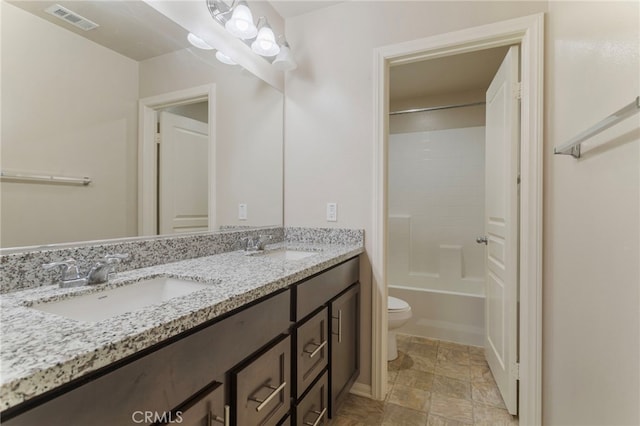 11462 Jacobsen Rd, Beaumont, CA 92223 - full bath with double vanity, stone finish floors, and shower / tub combination