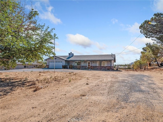 7423 Palomar Ave, Yucca Valley, CA 92284 - single story home featuring an attached garage, asphalt driveway, a chimney, and a porch