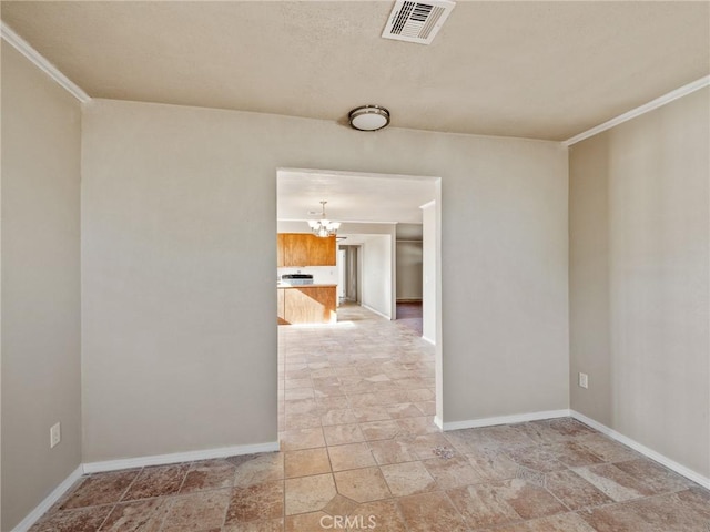 7423 Palomar Ave, Yucca Valley, CA 92284 - empty room featuring a chandelier, light stone finish flooring, and ornamental molding