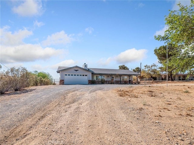 7423 Palomar Ave, Yucca Valley, CA 92284 - single story home with a garage and dirt driveway