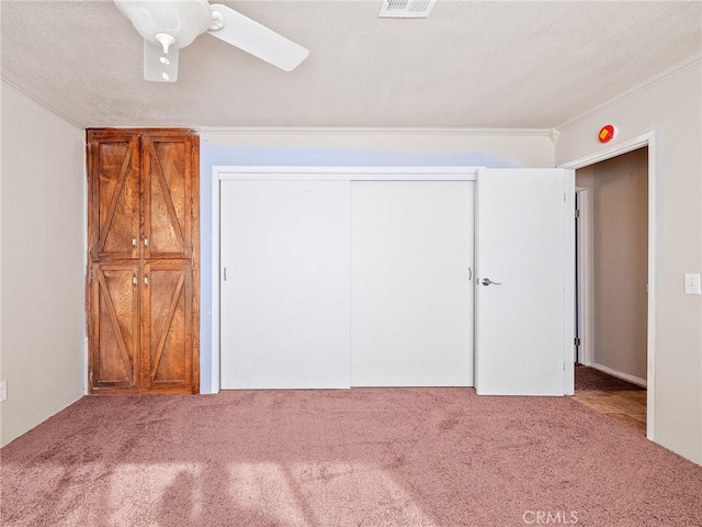 7423 Palomar Ave, Yucca Valley, CA 92284 - unfurnished bedroom with carpet flooring, a closet, ceiling fan, and crown molding