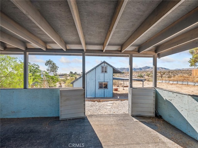 7423 Palomar Ave, Yucca Valley, CA 92284 - view of patio / terrace with a mountain view and an outbuilding