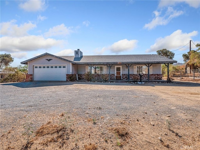 7423 Palomar Ave, Yucca Valley, CA 92284 - single story home with a garage, a porch, driveway, and a chimney
