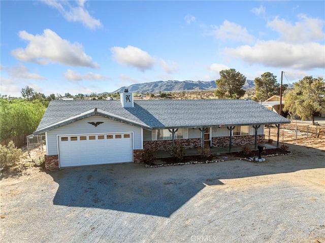 7423 Palomar Ave, Yucca Valley, CA 92284 - view of front facade with an attached garage, brick siding, driveway, and a porch